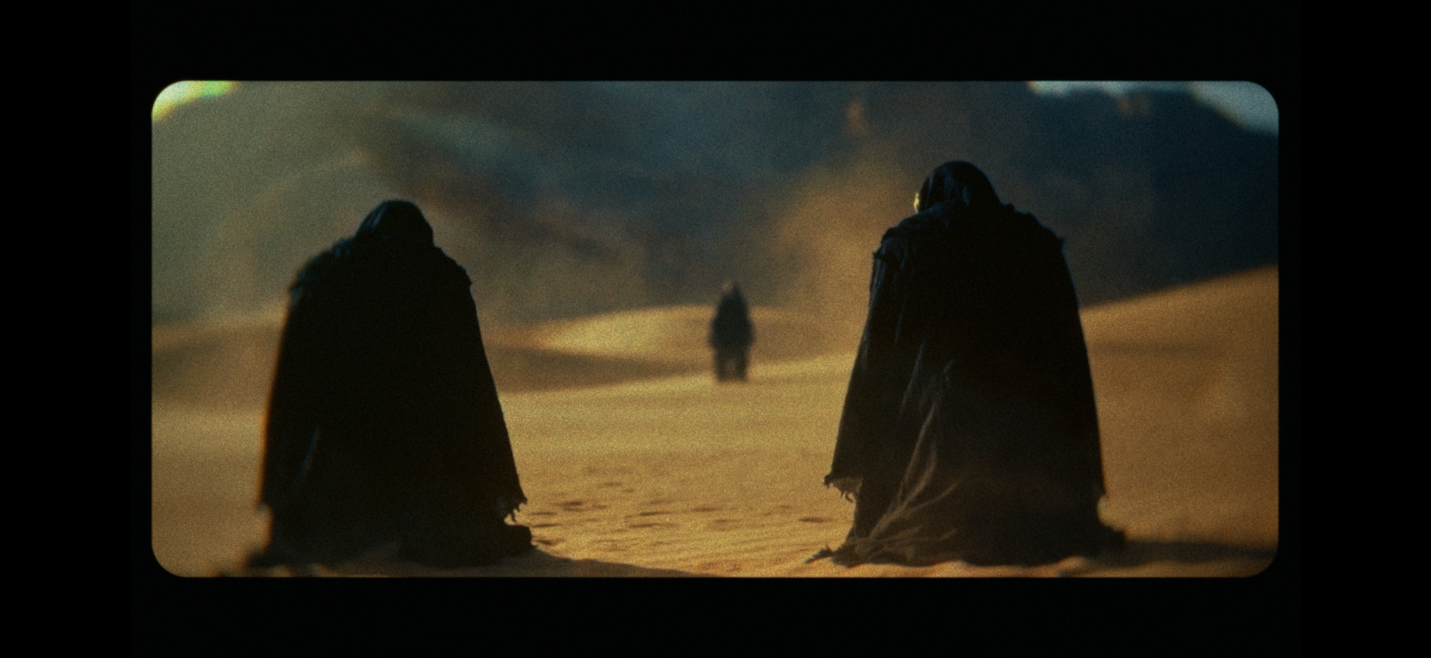Masked keepers waiting in the desert in The Obelisk